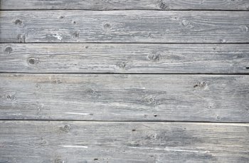 A background of weathered gray painted wood