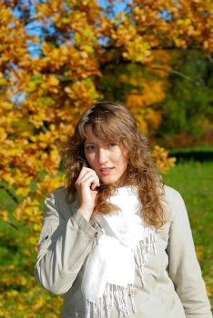 young fresh woman calling by phone in autumn