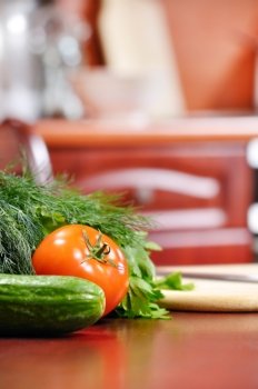 ripe vegetables is liying on table in kitchen