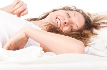 beautiful happy caucasian woman is lying in bed at morning