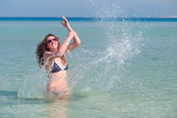 funny woman splasing in the sea