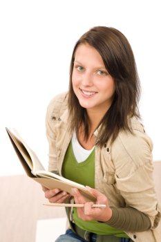 Student teenager girl holding books looking up to camera