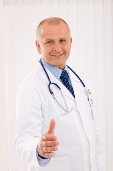 Happy mature doctor male giving handshake welcoming portrait
