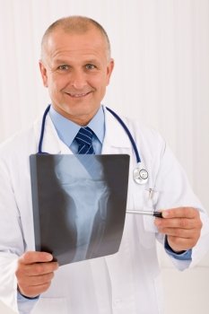Portrait of professional male doctor hold and point x-ray