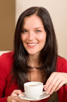 Young attractive woman enjoying cup of coffee