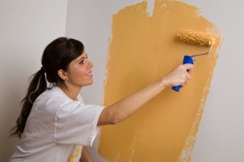 a young woman paints from her new apartment. color brings joy to life.