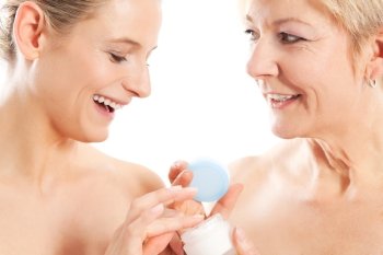 Beauty and skin care - mother and daughter with cream