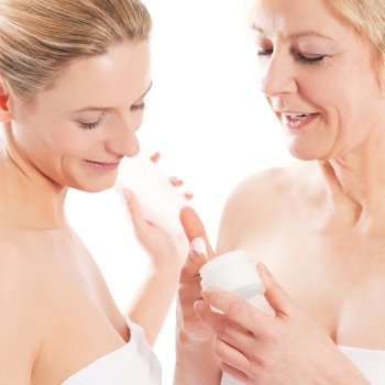 Beauty and skin care - mother and daughter with cream