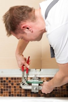 Plumber installing a mixer tap in a bathroom 