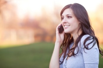 A portrait of a smiling beautiful woman talking on the phone