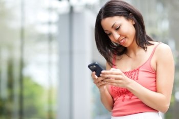 A shot of a mixed race woman texting on her cell phone