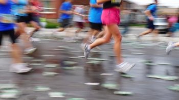 Blurring runners in a marathon running race.