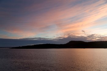 Silhouette of an island at dusk, Puerto Baquerizo Moreno, San Cristobal Island, Galapagos Islands, Ecuador