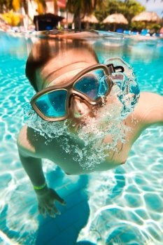 teenager floatsunder water in pool