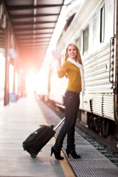 A shot of a beautiful young Caucasian woman traveling pulling a luggage