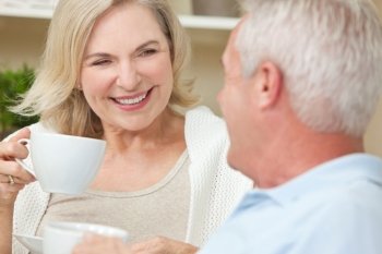 Happy Senior Man & Woman Couple Drinking Tea or Coffee