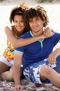 Portrait teenage couple on beach