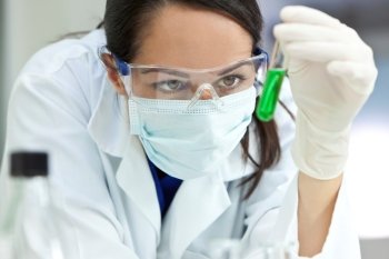 Female Laboratory Scientist or Doctor with Green Liquid Test Tube