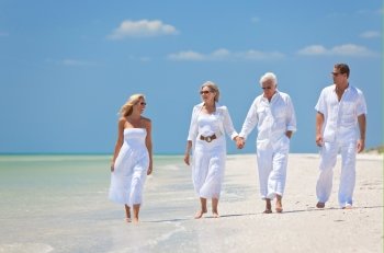 Two Couples Generations of Family Walking on Tropical Beach
