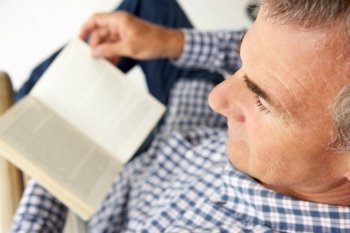 Mid age man reading a book