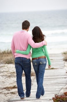 Couple walking by the sea