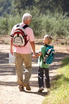Senior man and grandson on country walk