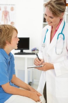 Female doctor talking to young boy