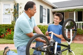 boy and grandfather fixing bike