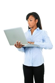 Young serious black woman working with laptop computer