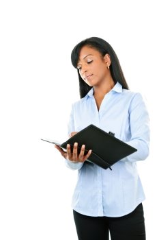 Young serious black woman writing in leather portfolio folder