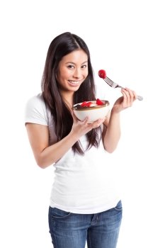 An isolated shot of an asian woman holding a bowl of fruit