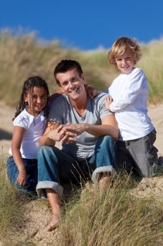 Father, Son & Mixed Race Daughter Sitting on Beach