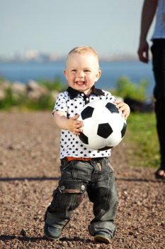little boy play soccer outdoor