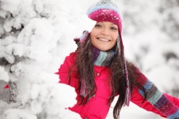 winter girl behind snow tree