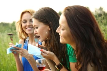 women drink wine on piknic