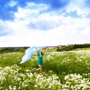 girl run by field fabric in hands fly behind like wings
