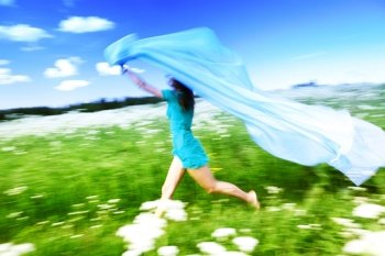 girl run by field fabric in hands fly behind like wings