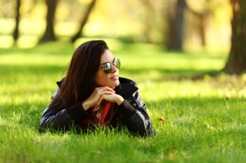 woman lay on green grass in park