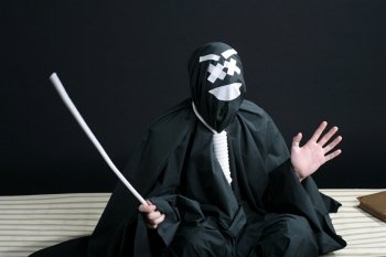 Black mime with rope on neck on black background