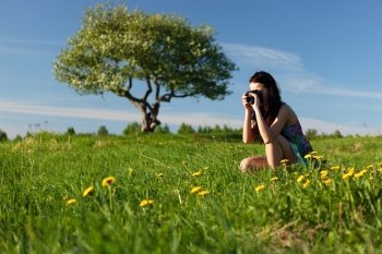 woman photographer on green grass field