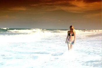 girl walking in the ocean waves