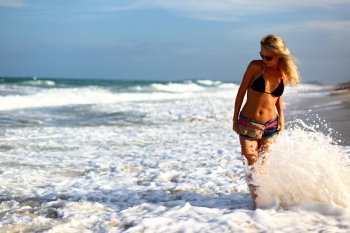 girl walking in the ocean waves