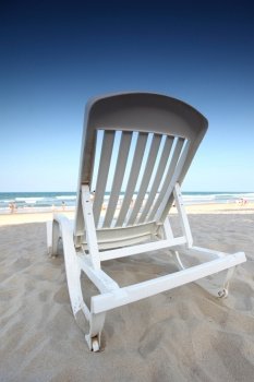 chair on sand and ocean background