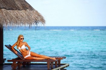 woman on lounge sea on background