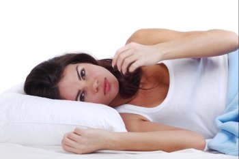 waking woman on the white pillow