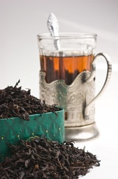 dry tea leaves in a box and glass