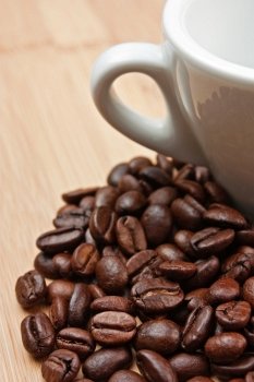 coffee beans and cup on a wooden background