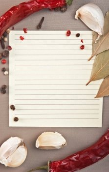 blank sheet for cooking recipes and spices on the kitchen table