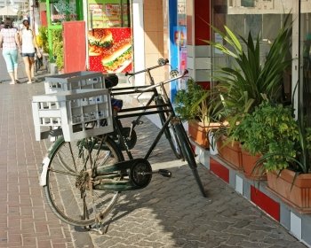 two bike with drawers are standing on the sidewalk near the store