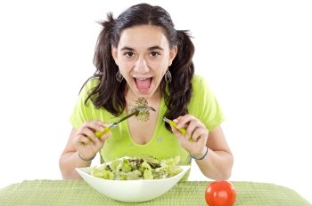 Pretty teenager eating salad over white background
